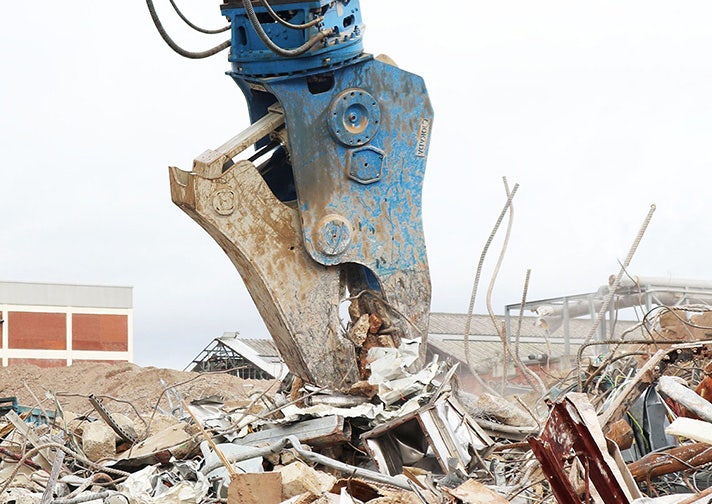 Abbruchwerkzeug von Okada zerdrückt Bauschutt auf einer Baustelle